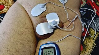 Dominatrix Nika plays with electric discharges on the genitals of the slave. Electrostimulation BDSM